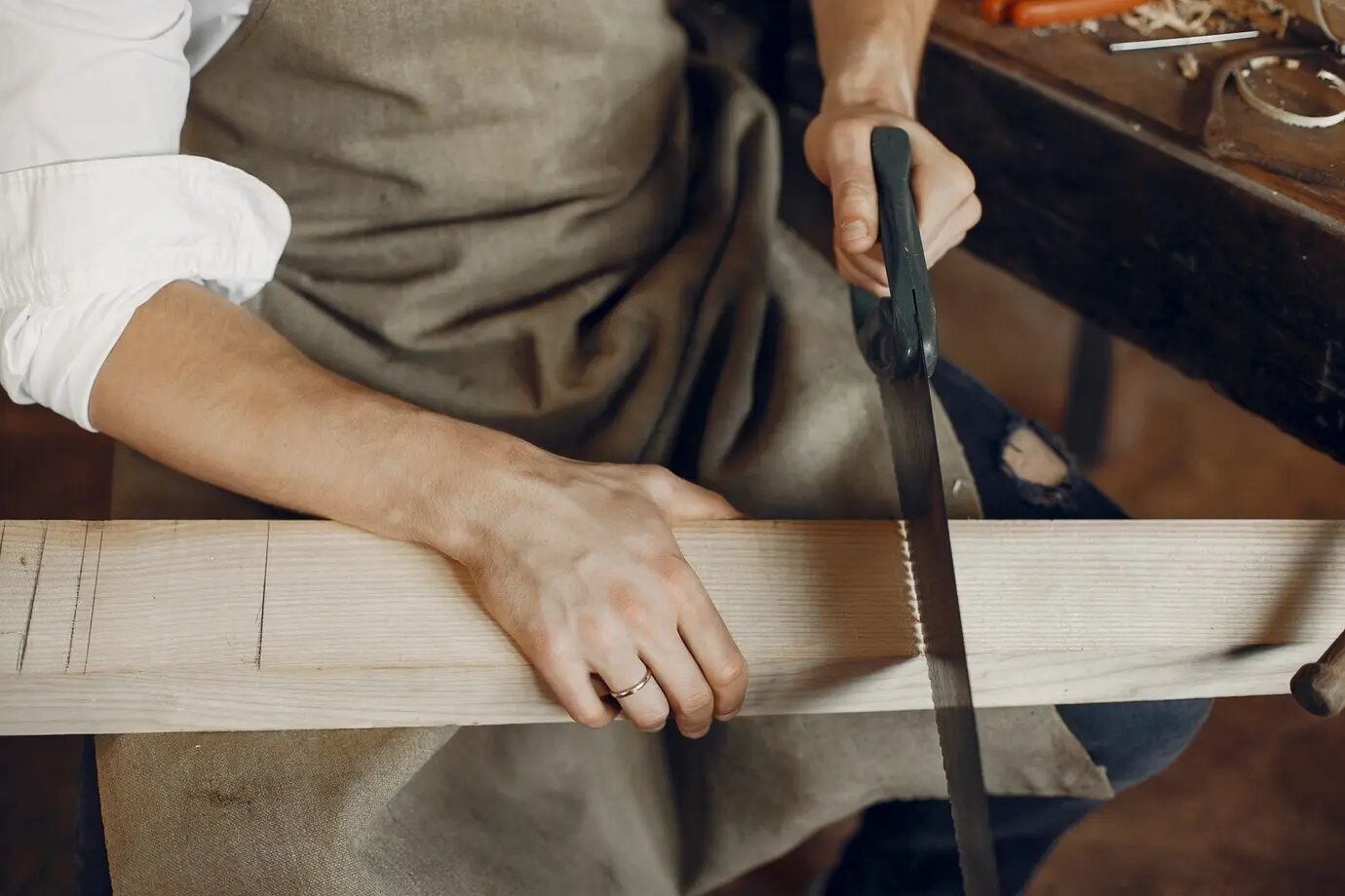A handsome carpenter working with wood.